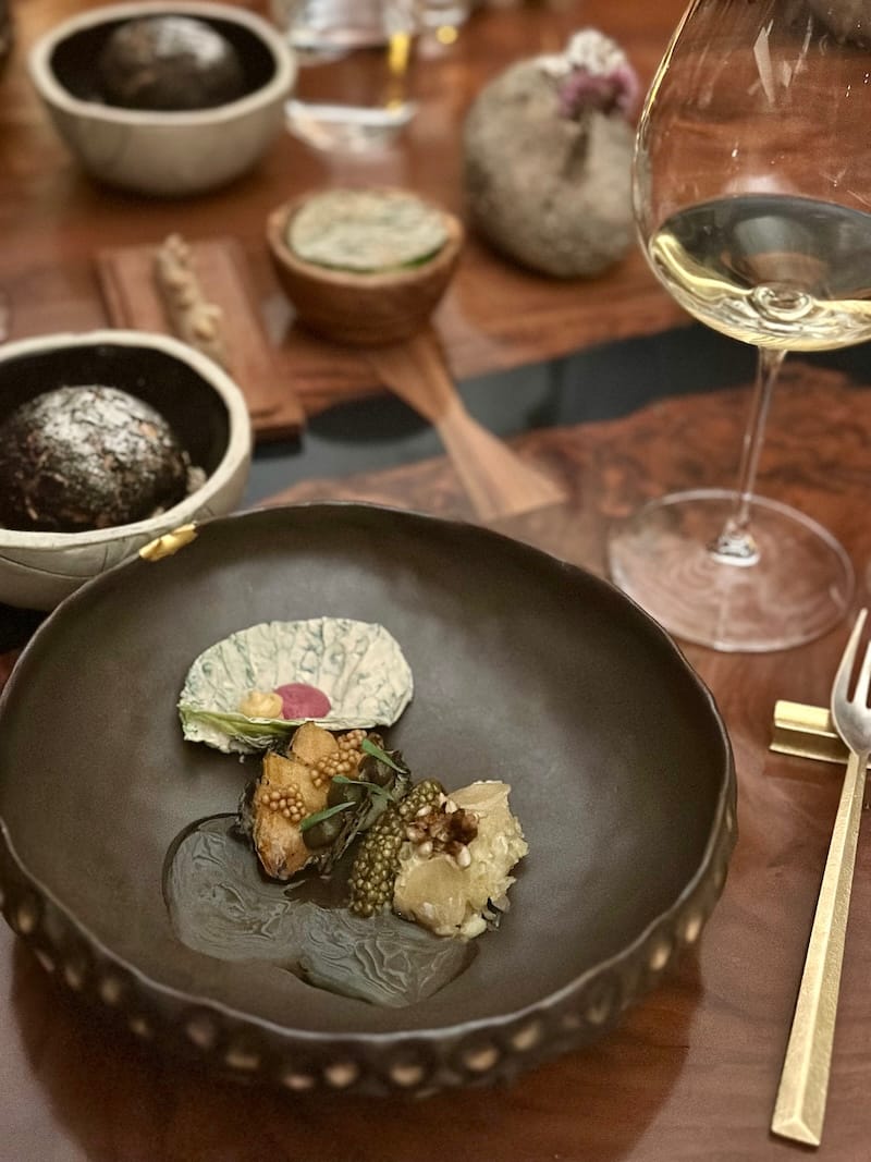 Seafood chic: grilled Monterey Bay abalone with smoked imperial ossetra caviar, housemade sauerkraut, and abalone XO sauce at Atelier Crenn. Photo: © tablehopper.com.