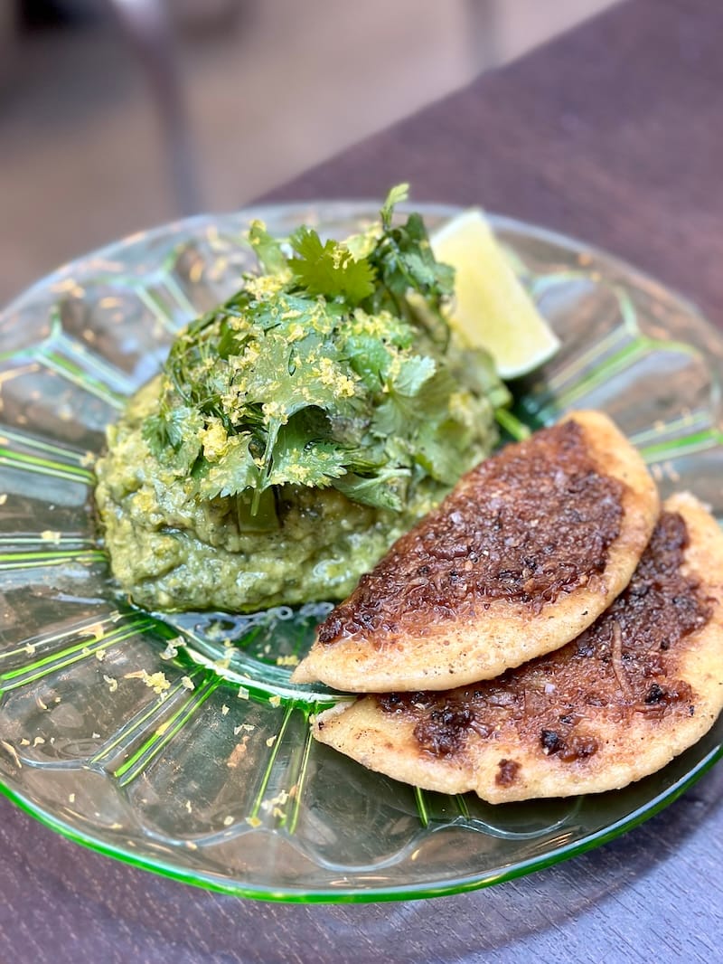 Guaca-mol with herbs, snap peas, yolk, and life-changing tortillas with asiento (crispy beef oil) on the back patio at Popoca in Old Oakland. Photo: © tablehopper.com.