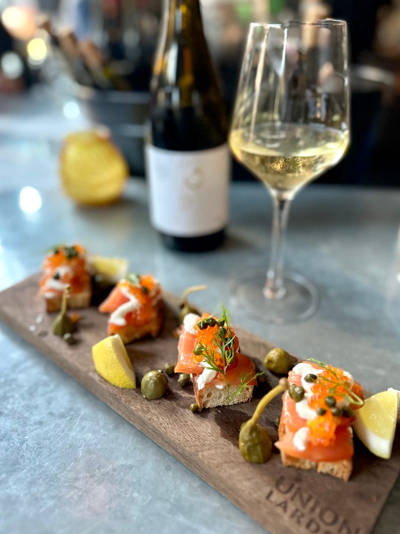 How to beat the heat: house-cured lox with smoked trout roe and horseradish crème fraîche with a glass of Peter Lauer Saar riesling sekt brut at the bar at Union Larder. Photo: © tablehopper.com.