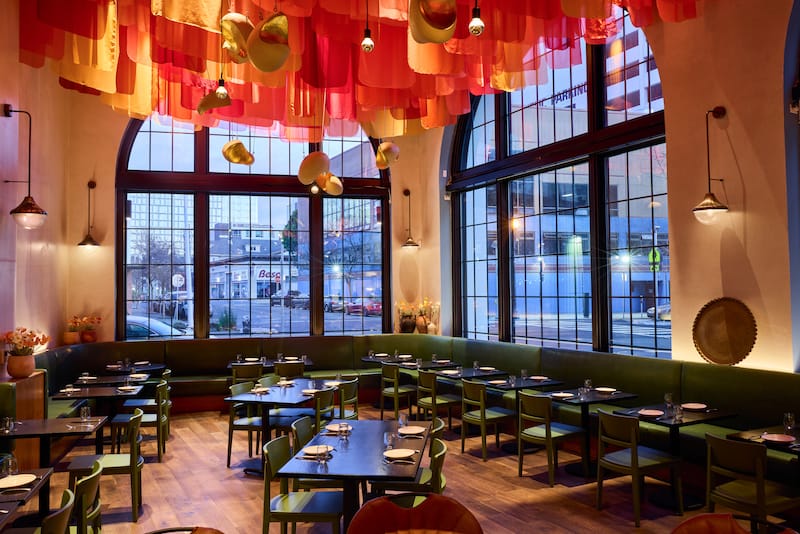 The spacious dining room is adorned with hanging silk fabric that represents the Afghan poppy. Photo: ⓒ Hardy Wilson.