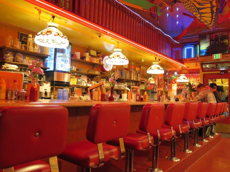 The iconic red chairs at the counter of Orphan Andy’s. Photo: © tablehopper.com.